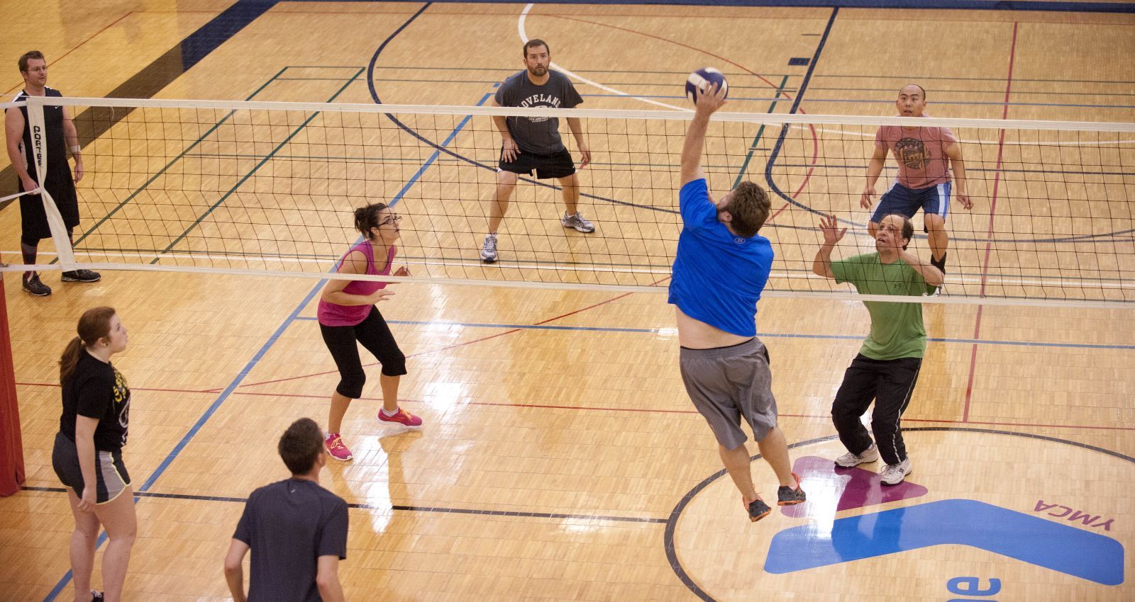 An image of adults playing volleyball