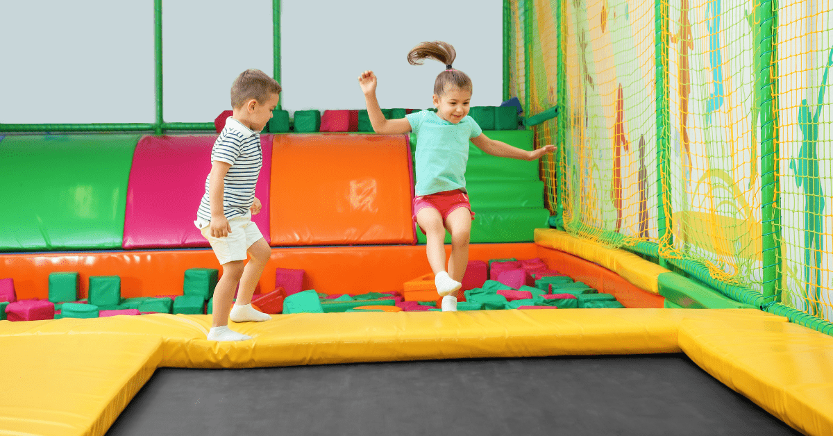 An image of kids jumping on a trampoline. 